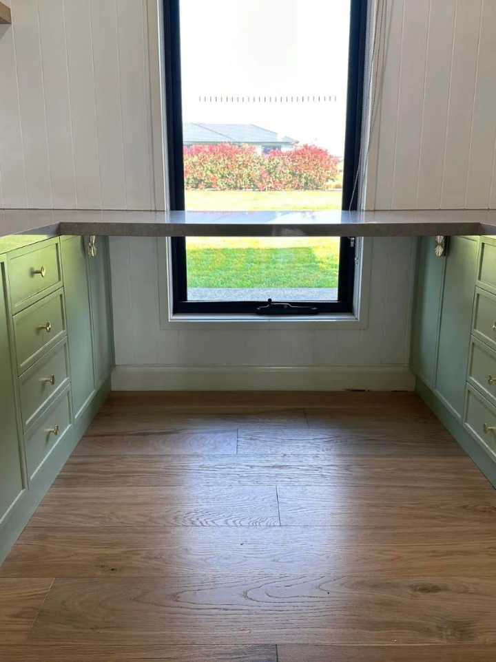 Langwarrin office with soft green shaker cabinets and oak shelves